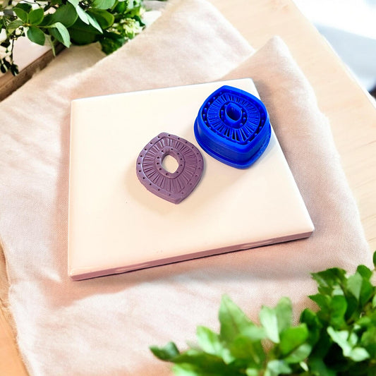 polymer clay piece with blue cutter