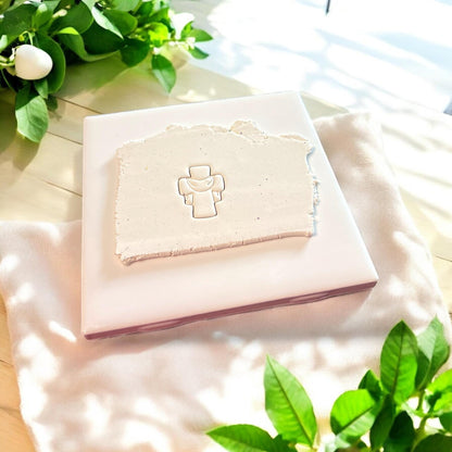 cross design embossed in clay