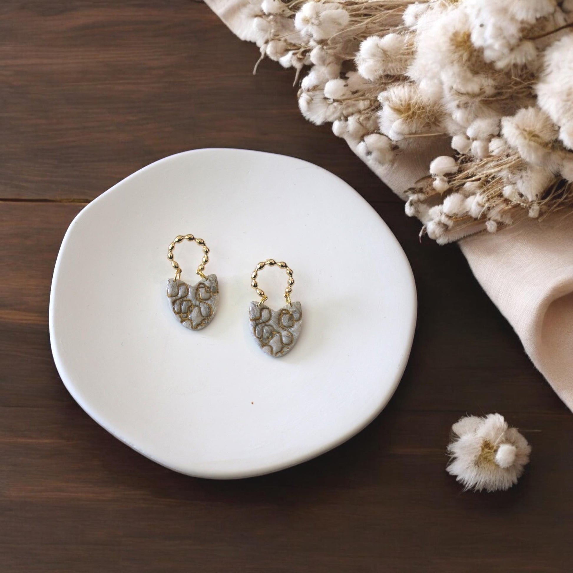 finished abstract earrings on tray