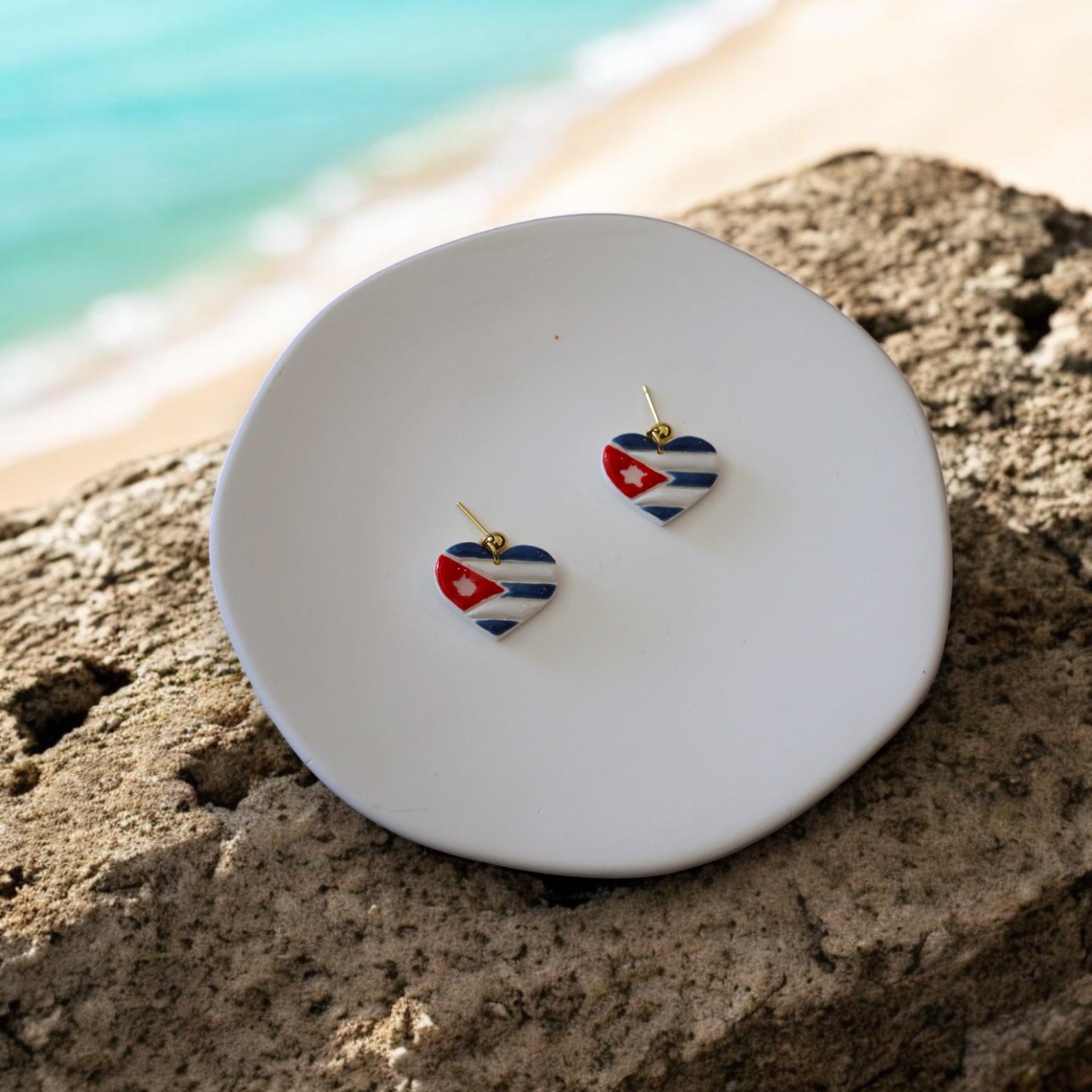 heart flag earrings on beach plate