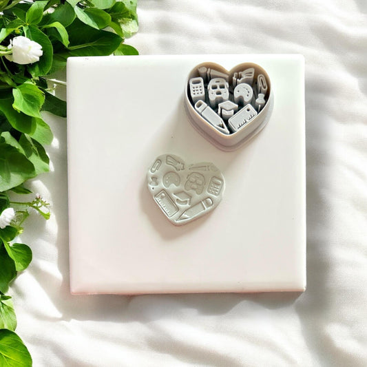 Finished clay shape beside heart-shaped cutter showing all school-themed elements