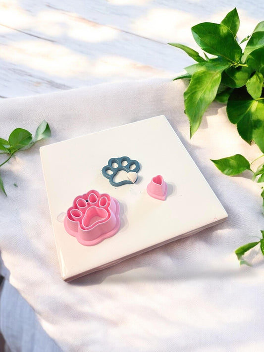 Pink polymer clay cutter set shown with the completed paw print and heart clay pieces for pet-themed earring making