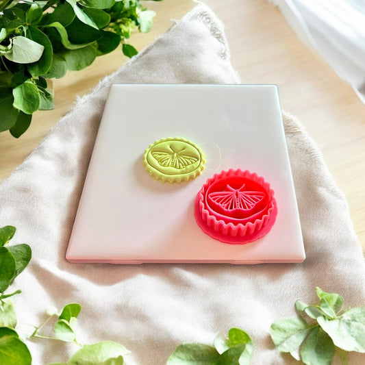 Completed butterfly design shown next to the matching cutter, demonstrating the clean and whimsical mold
