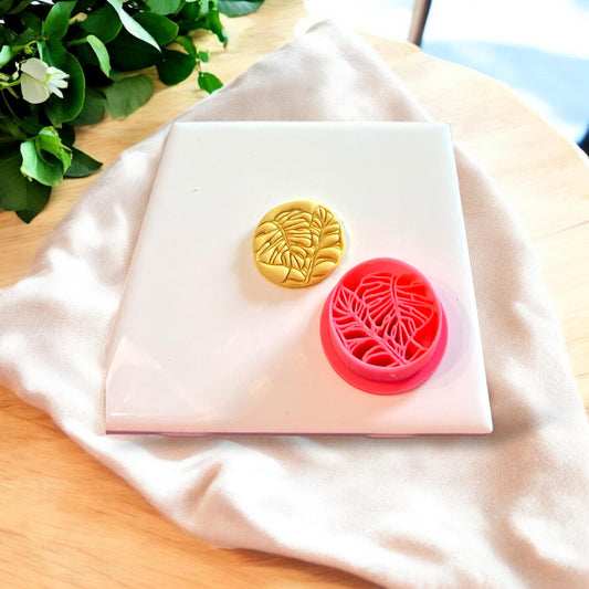 Monstera leaf cutter showcasing its use in polymer clay jewelry creation.