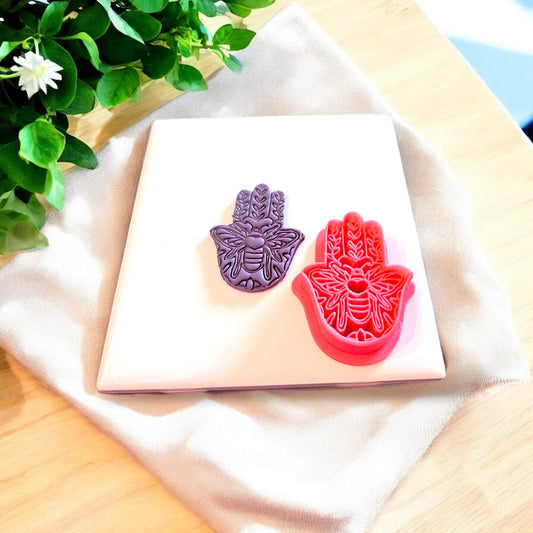 Hamsa clay cutter showcasing its use in creating yoga-inspired charms.