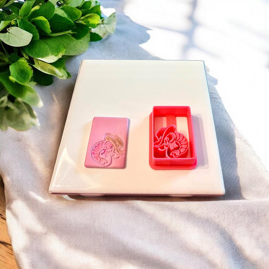 Polymer clay earring design and matching lobster cowboy hat cutter displayed side by side.