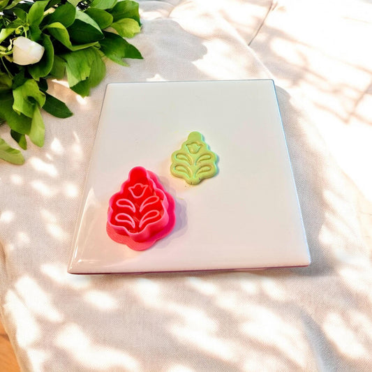 Bright red polymer clay cutter in Scandinavian folk flower shape