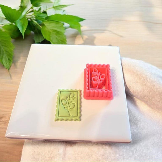 Comparison of lemon stamp cutter and clay result side by side on a ceramic tile surrounded by fresh leaves.