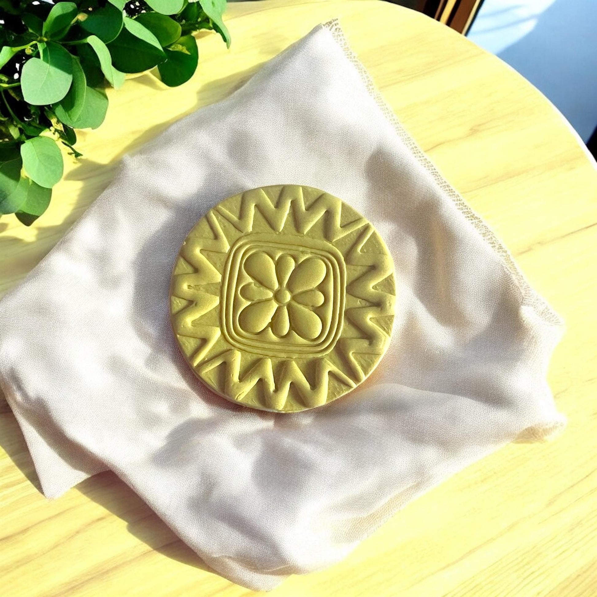Close-up of Scandinavian style floral circle clay cutter showing intricate petal details.
