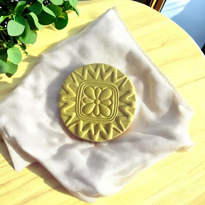 Close-up of Scandinavian style floral circle clay cutter showing intricate petal details.
