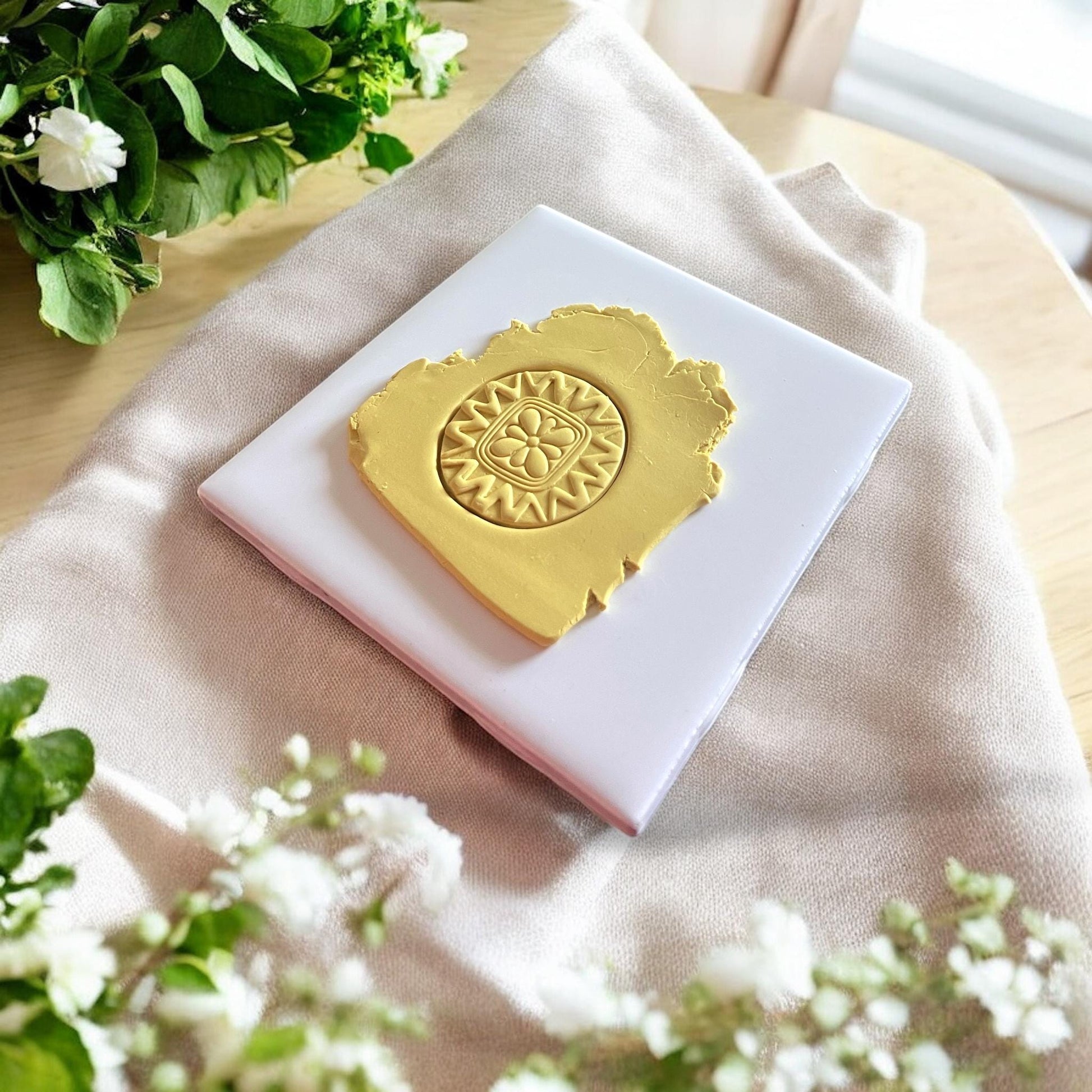 Close-up of Scandinavian style floral circle clay cutter showing intricate petal details.