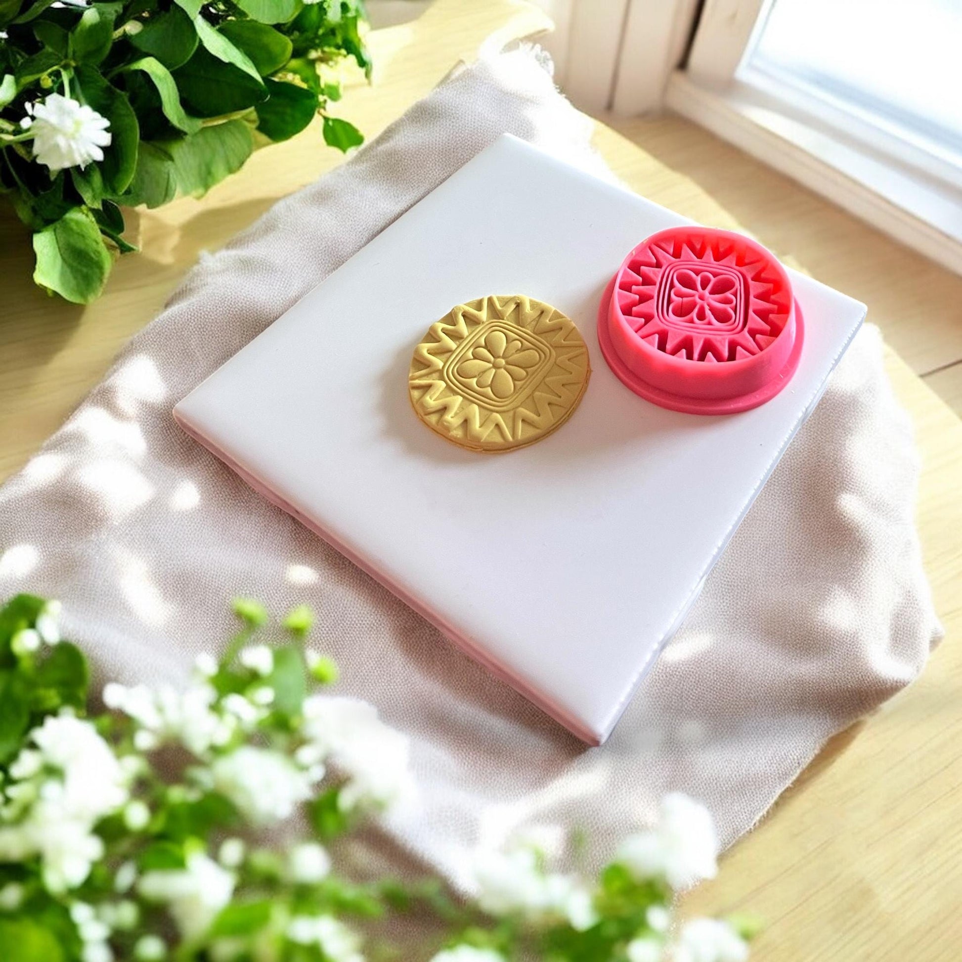 Polymer clay impression made with 37mm boho flower circle cutter on pastel clay slab.