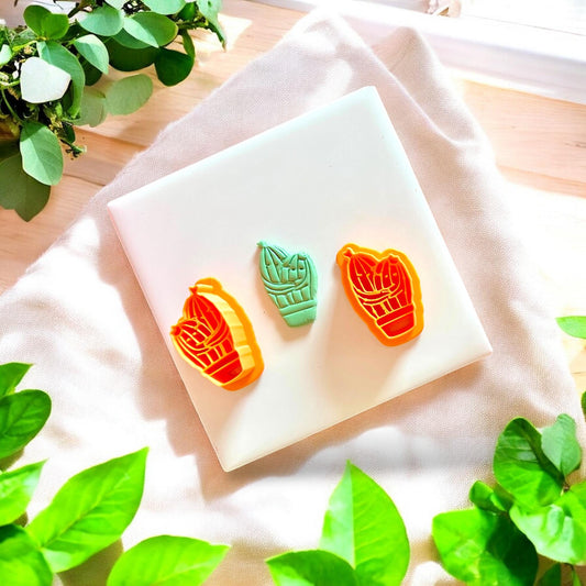 Green cactus clay piece shown with matching orange cutter set for earring making