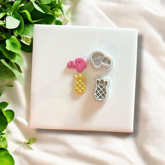 Flamingo and pineapple cutters in white on ceramic tile