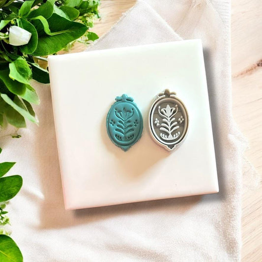 Folk flower charm and matching cutter side by side