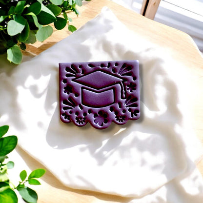 Grad cap cutter and finished clay piece