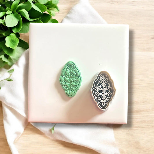 Side-by-side comparison of green clay cutout and floral clay cutter tool