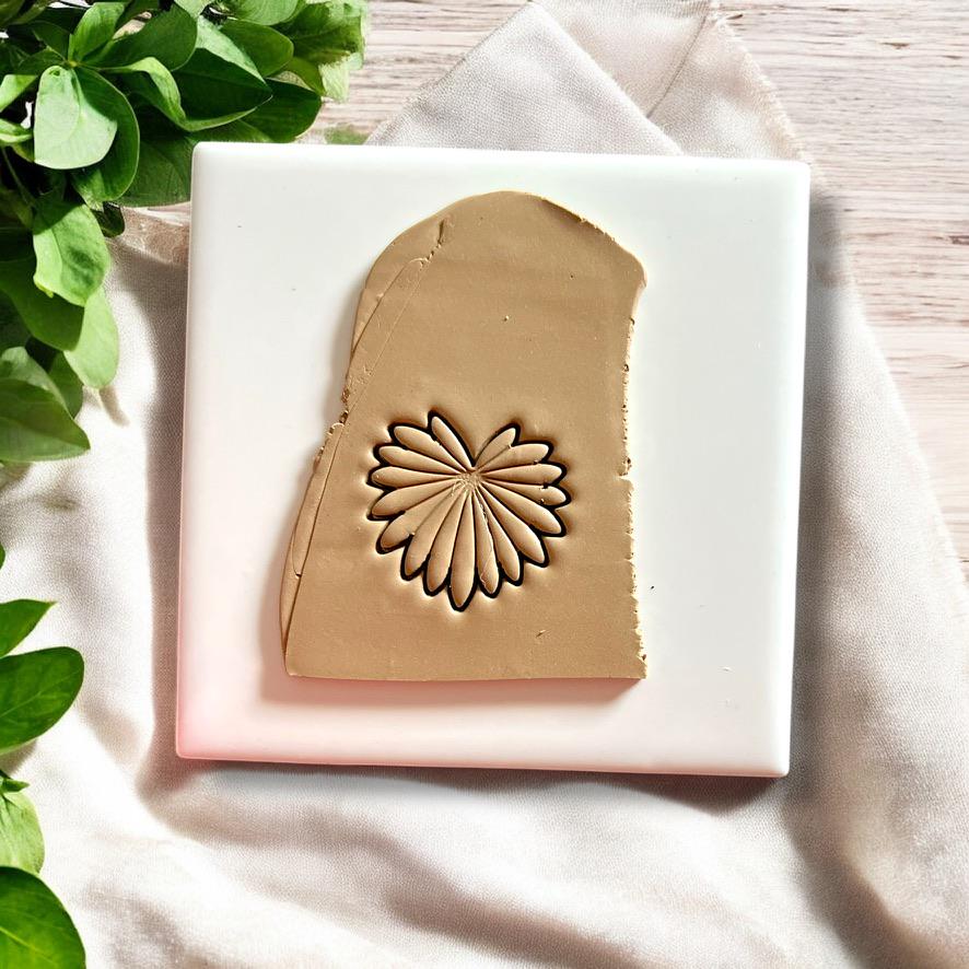 Polymer clay sheet showing palm leaf cutter impression for earring making