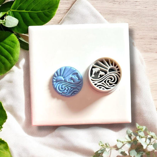 Dolphin sunshine clay cutter beside the finished clay earring