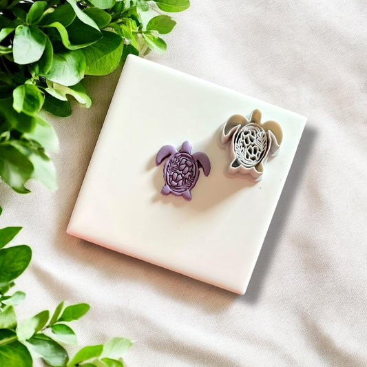 Side-by-side of turtle clay design and matching 3D cutter tool on white tile