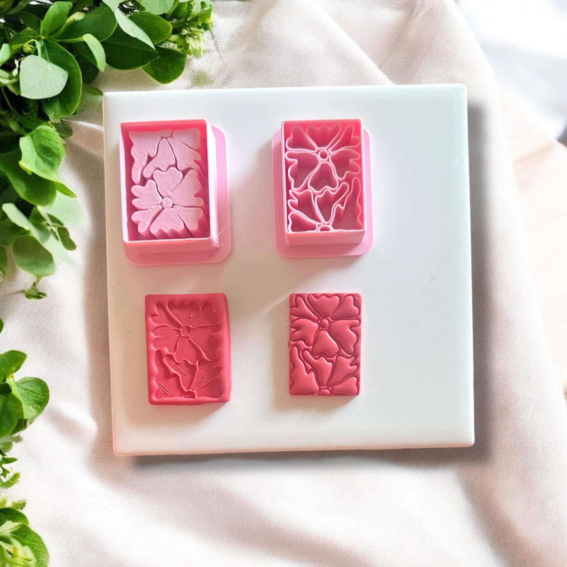Completed polymer clay earrings made using the Matisse flower cutter, displayed on a neutral background.