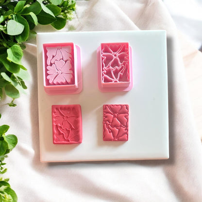 Completed polymer clay earrings made using the Matisse flower cutter, displayed on a neutral background.