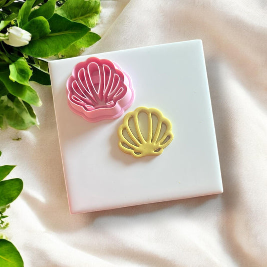 Shell cutout cutter placed on a slab of polymer clay, ready for cutting.