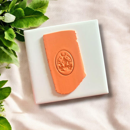 Front view of the yoga pose polymer clay cutter depicting a seated woman silhouette.