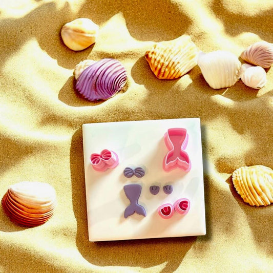 Mermaid tail, bow, and shell cutter set for polymer clay jewelry making.