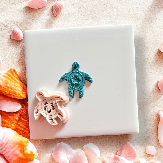 Finished floral sea turtle clay cutout on white tile