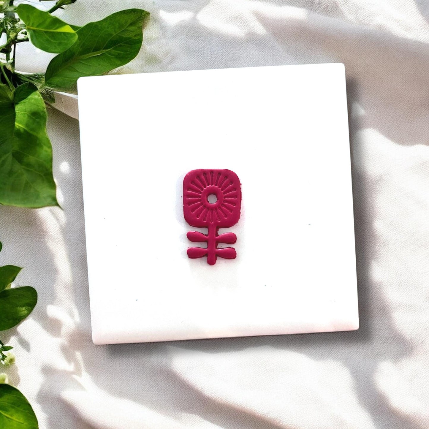 Cut red clay floral piece shaped like modern scandi flower