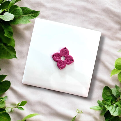 Finished clay piece in a floral boho shape with visible center opening