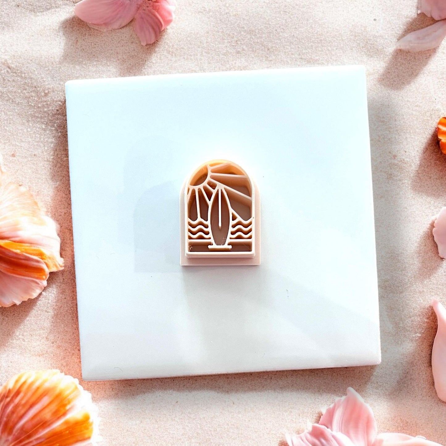 Close-up of arch cutter on white tile in soft lighting