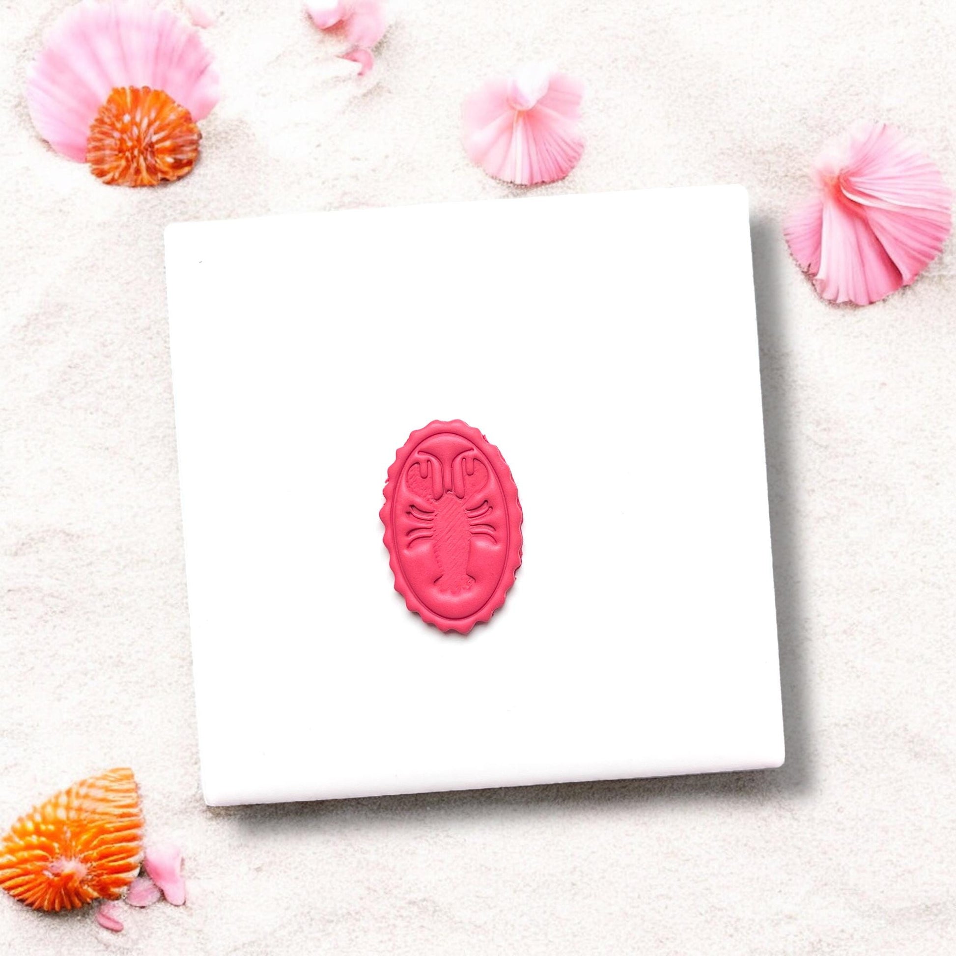 Completed oval lobster design in pink polymer clay