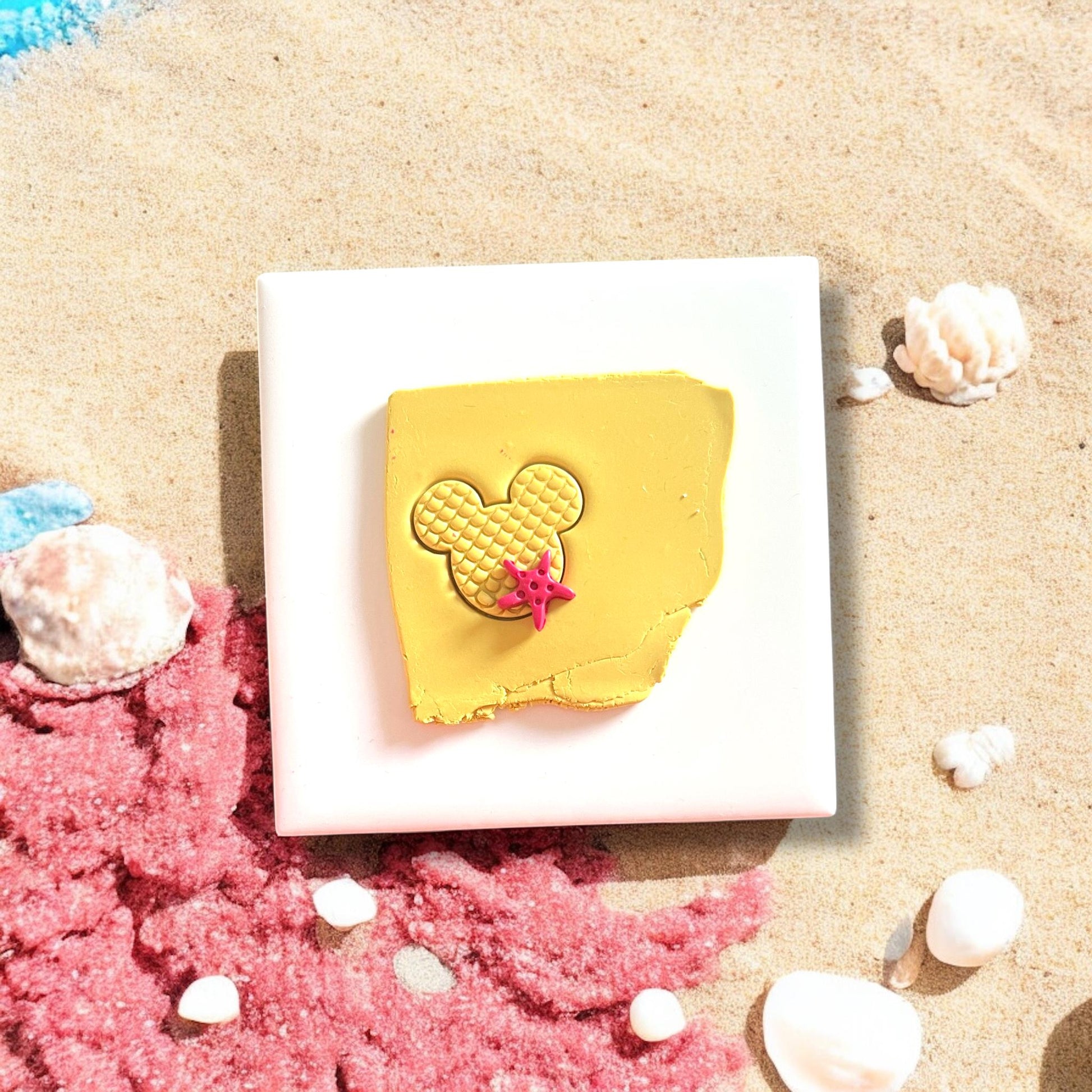 mouse mermaid earring cutter on yellow clay with starfish