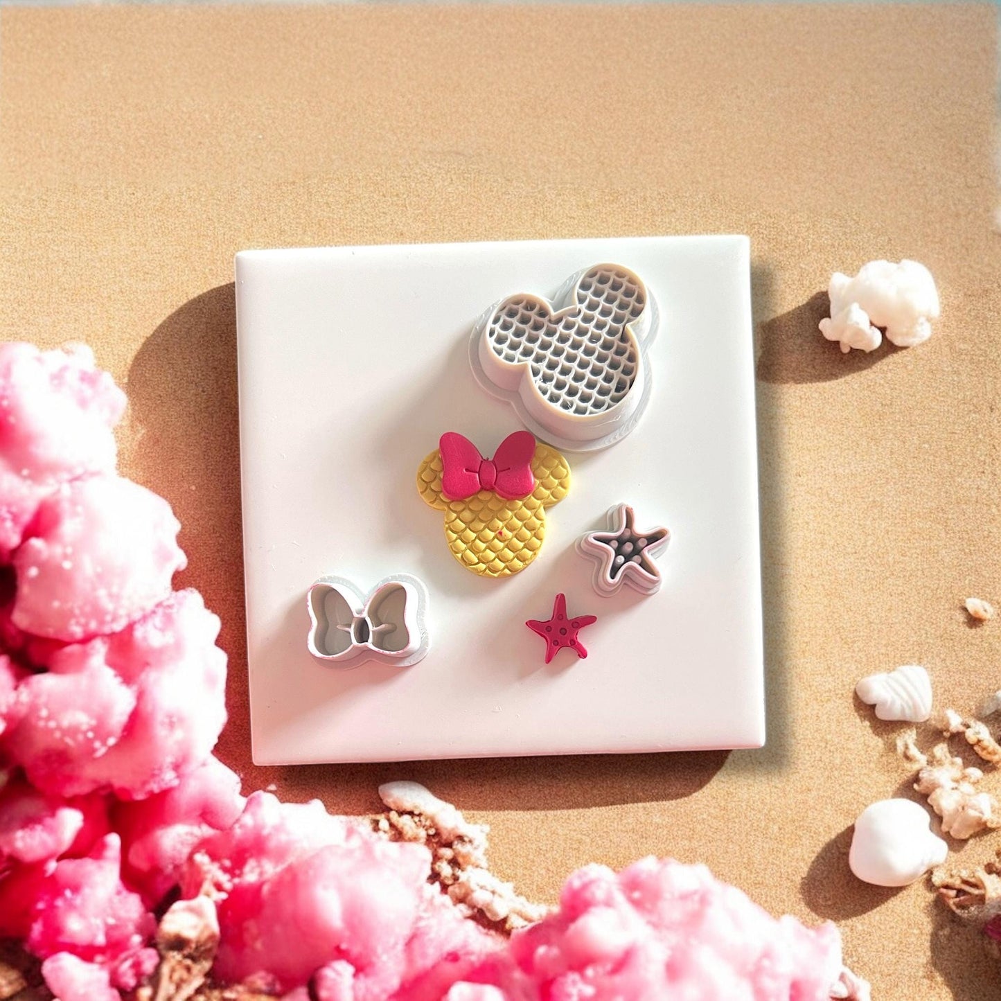 all clay cutters from mouse mermaid set displayed on beach background