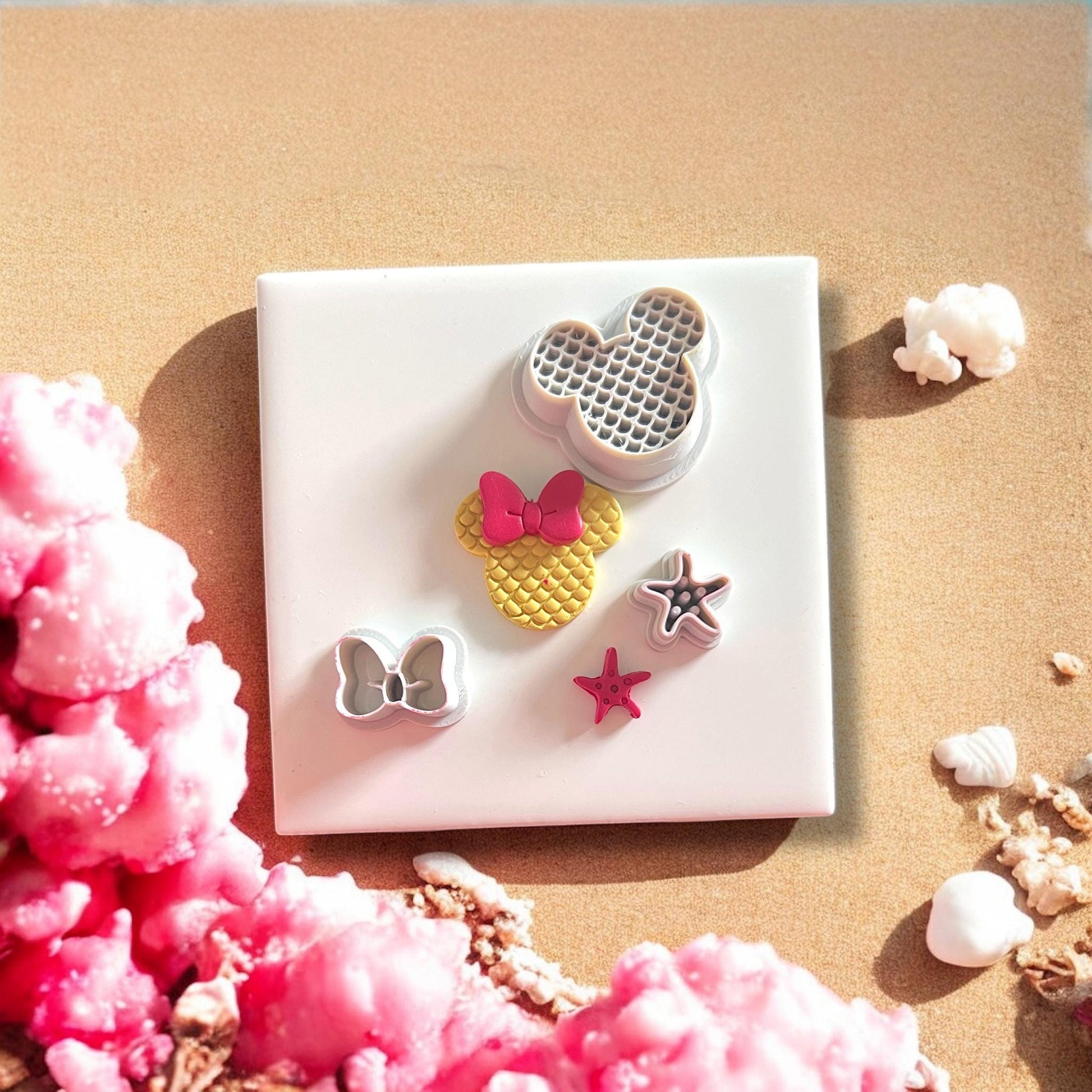 all clay cutters from mouse mermaid set displayed on beach background