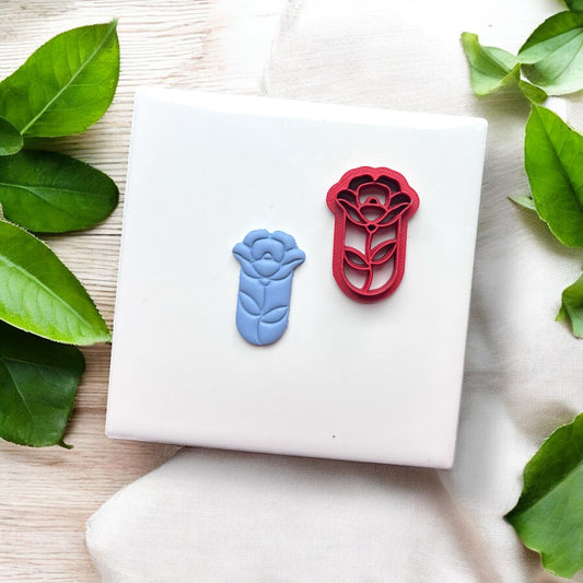 Red cutter next to matching clay flower shape