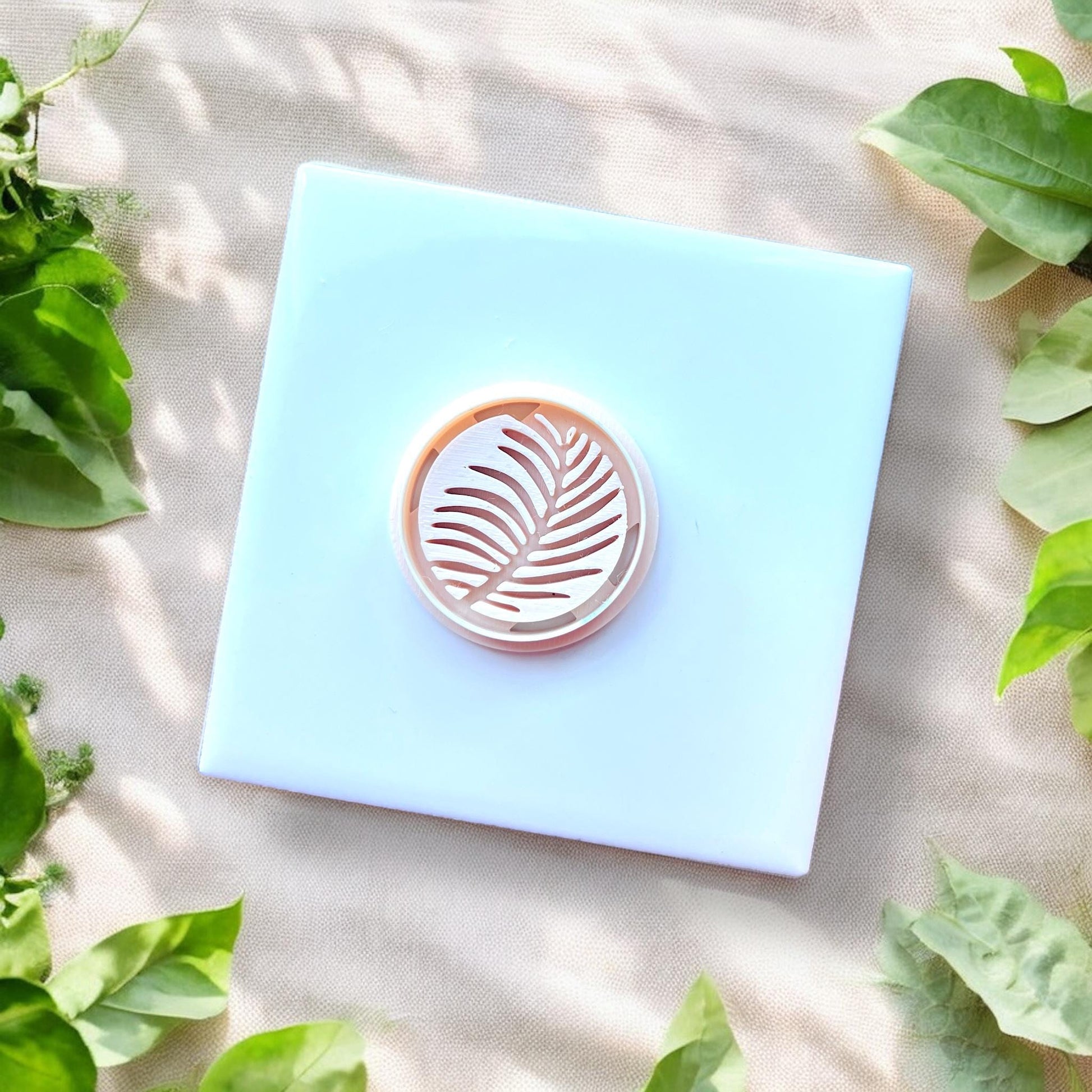 white round cutter with palm leaf detail