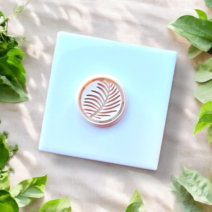 white round cutter with palm leaf detail