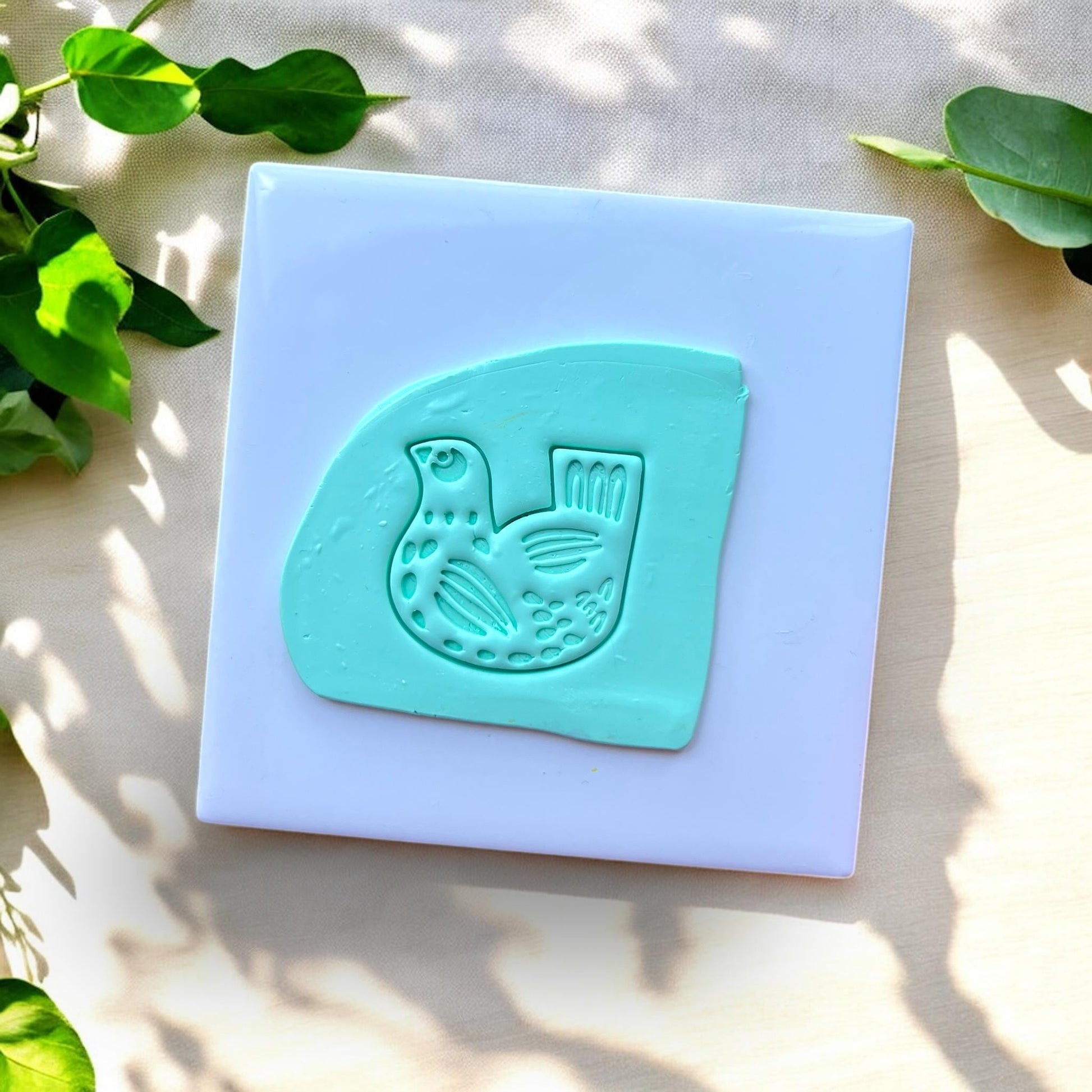 clay slab with folk art bird impression