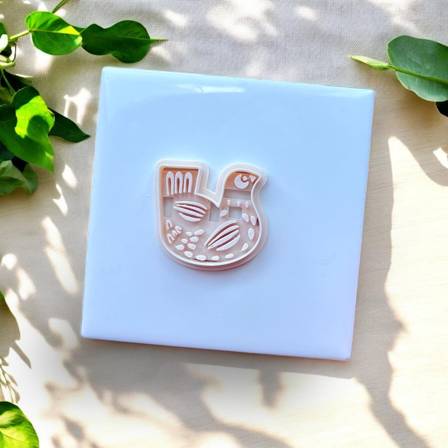 white cutter with carved folk bird details