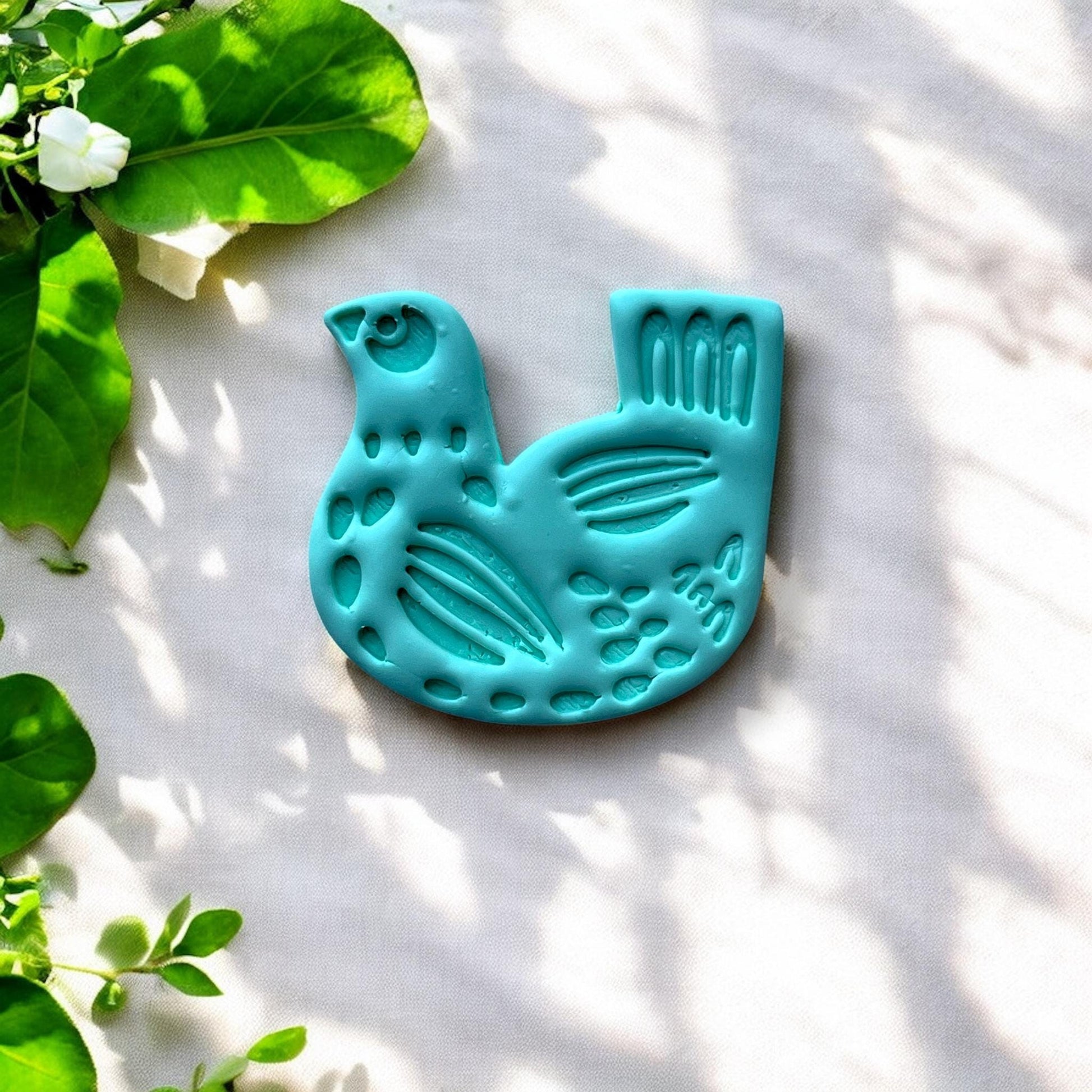 finished clay charm of stylized folk art bird