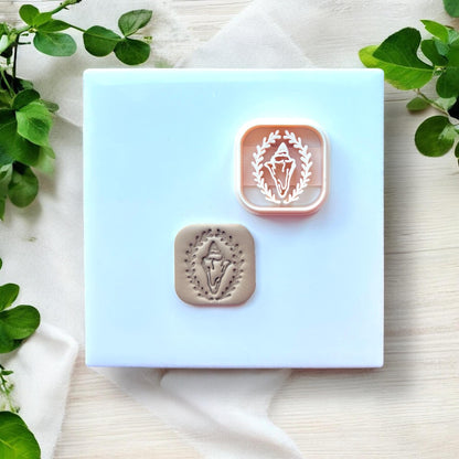 beige shell clay charm next to matching cutter
