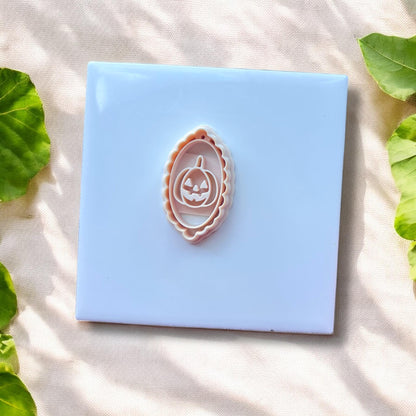 white oval cameo cutter with jack-o&#39;-lantern design