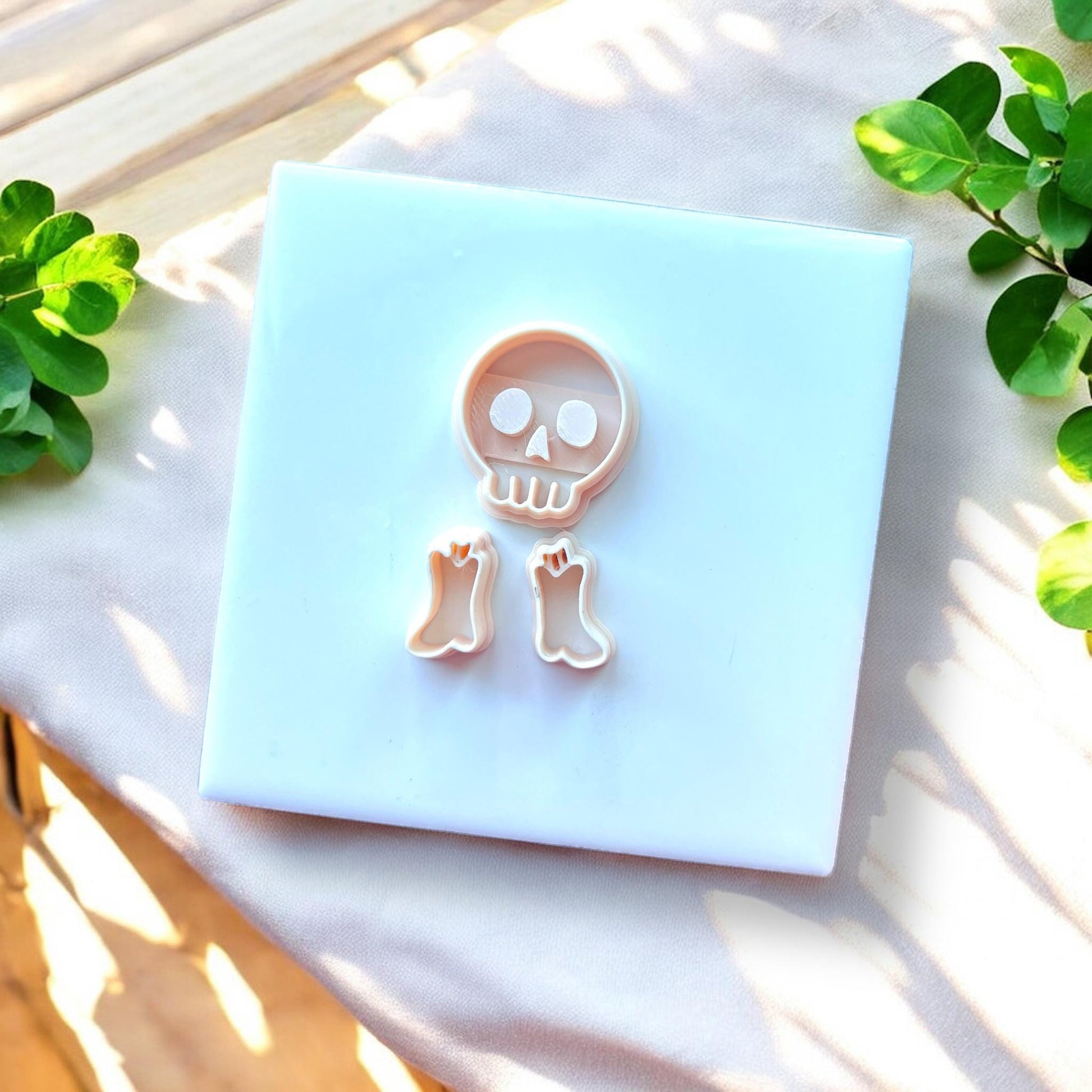 cutter set with skull and boots on white square tile