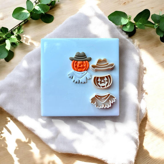 Pumpkin cowboy clay piece beside matching cutters for all 3 components