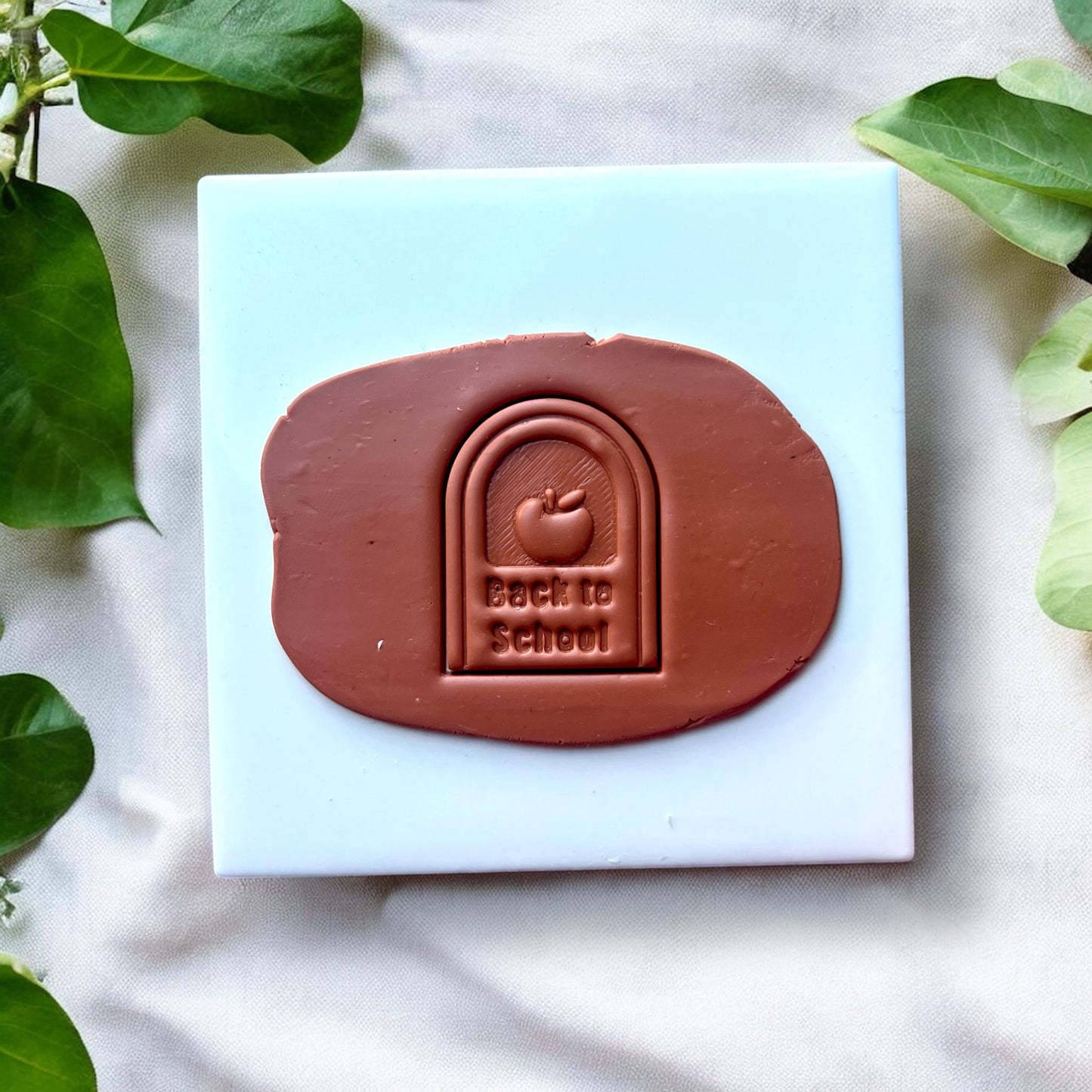 Clay slab with “Back to School” arch impression and apple design