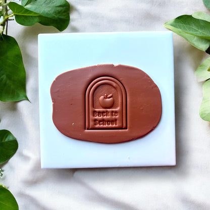 Clay slab with “Back to School” arch impression and apple design