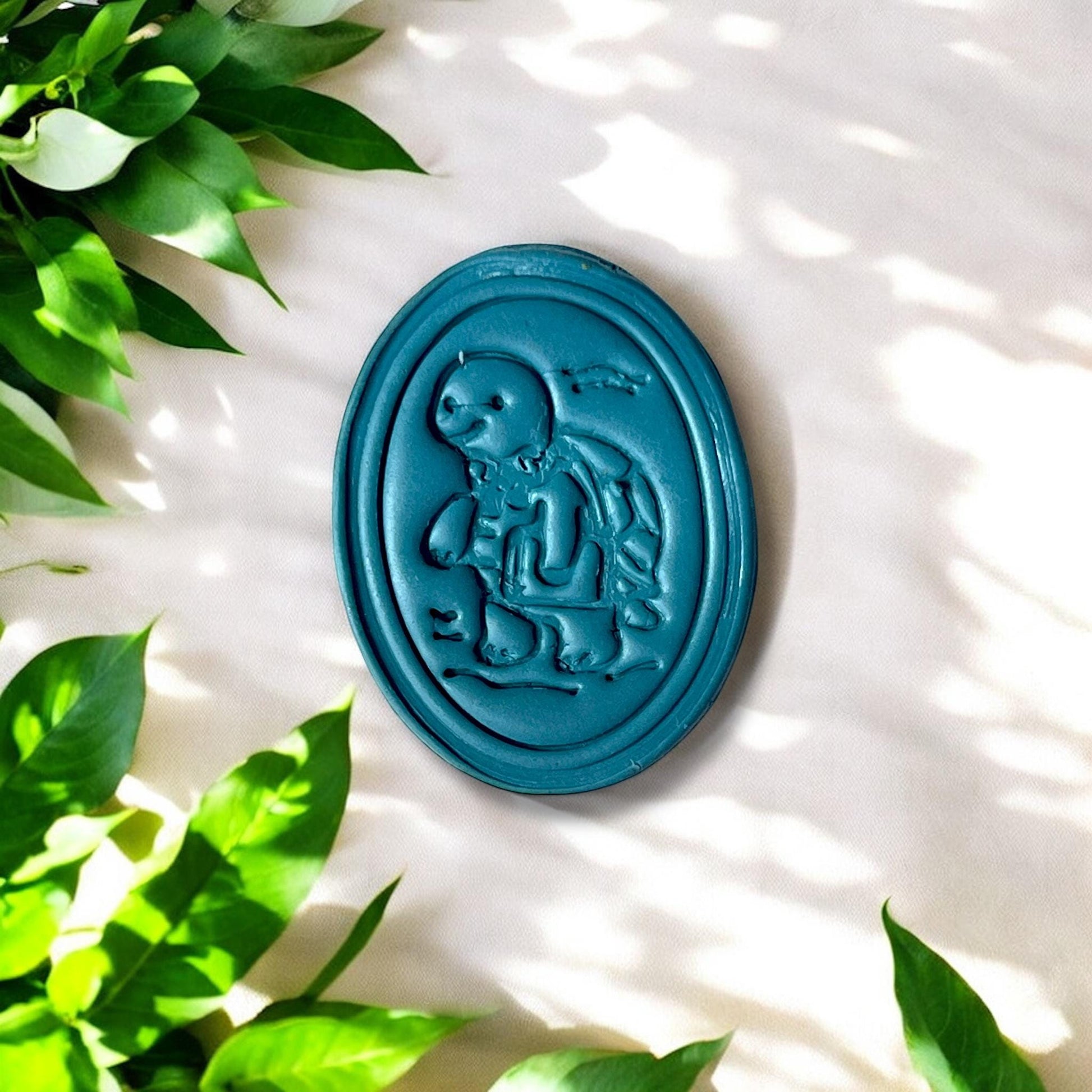 Finished clay oval with school turtle and subtle waves